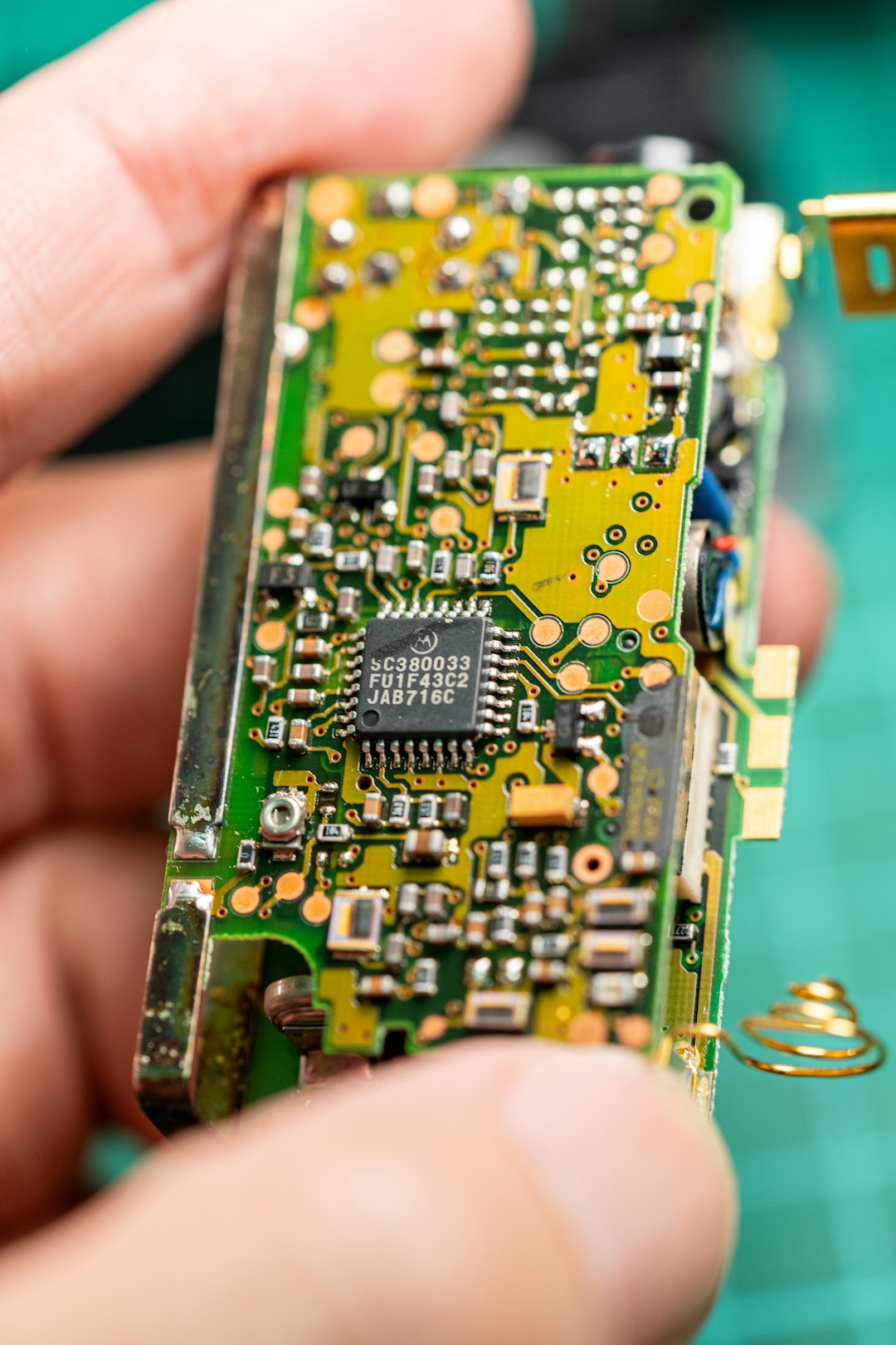 A close up of a person holding a small electronic device