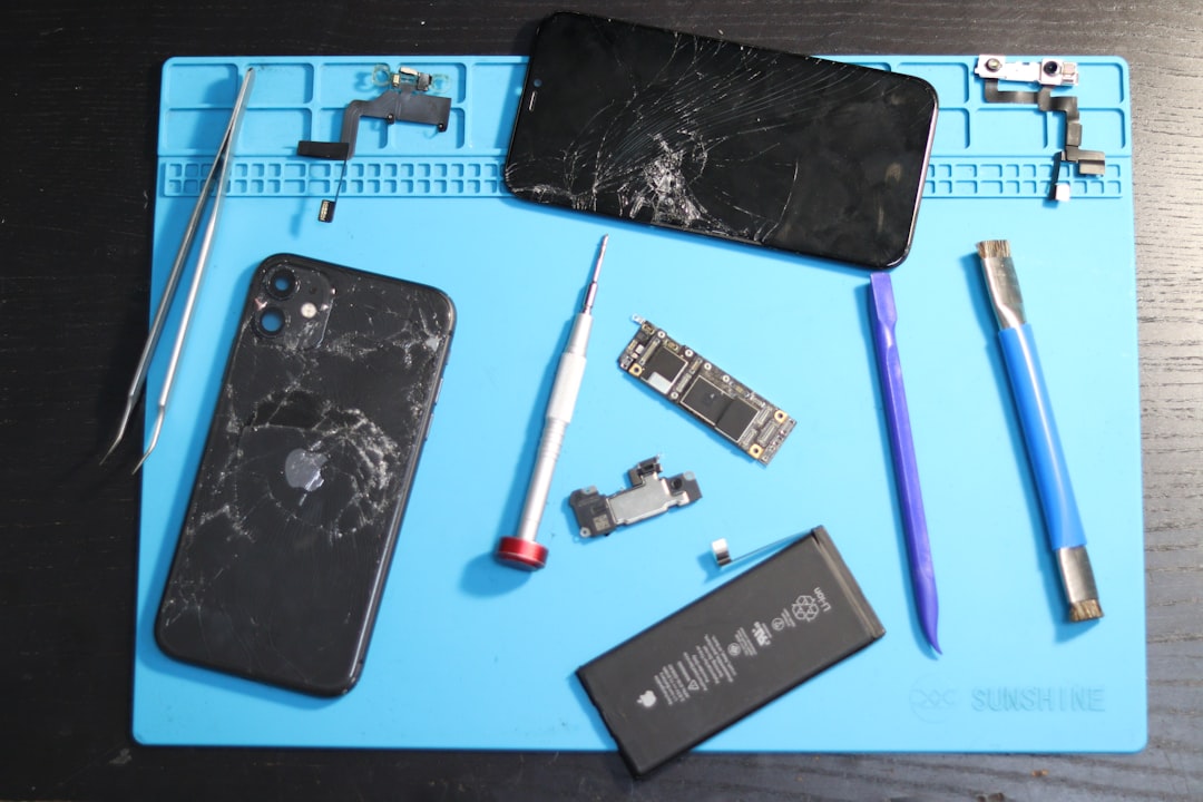 Cracked phone disassembled for repair.