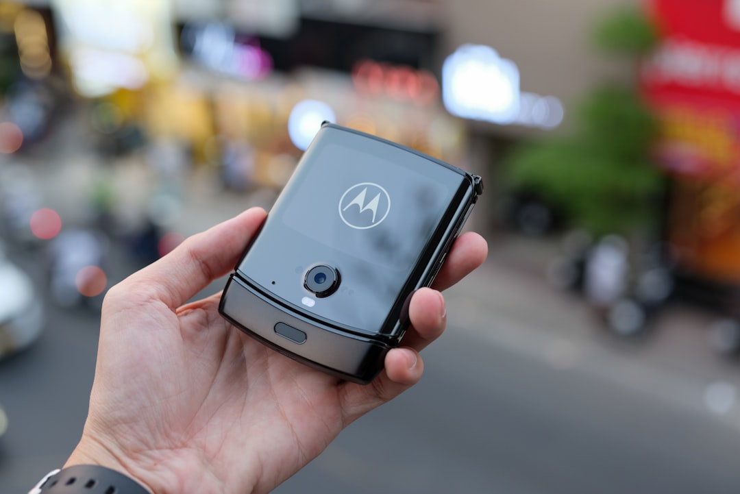 a person holding a smart phone in their hand