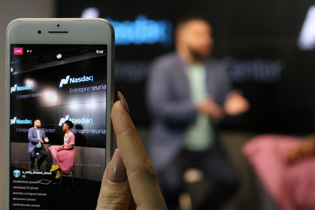 iPhone displaying man and woman sitting while facing each other chatting