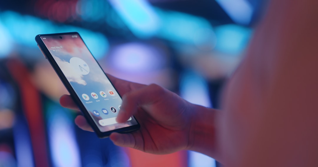 a person holding a cell phone in their hand