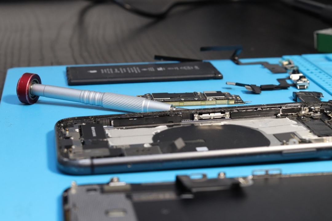 An iPhone is being repaired with components.