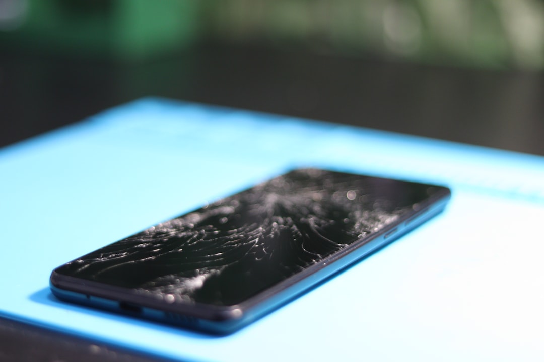The phone's screen is severely cracked.