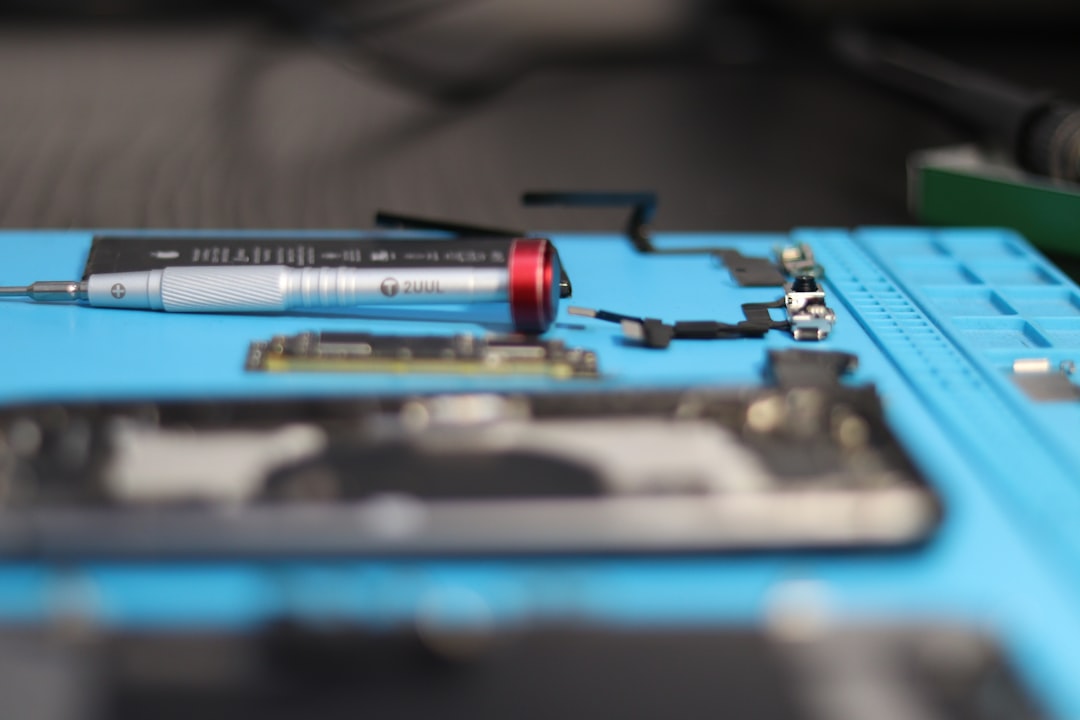 Phone parts are being repaired on a mat.