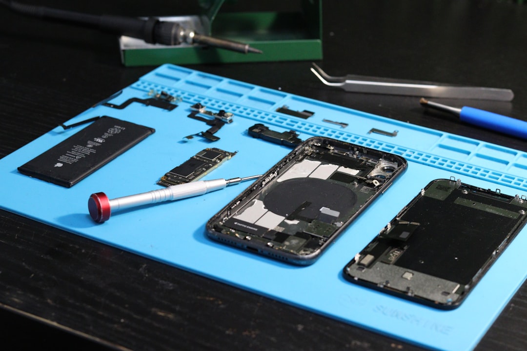 Phone components and tools are laid out for repair.