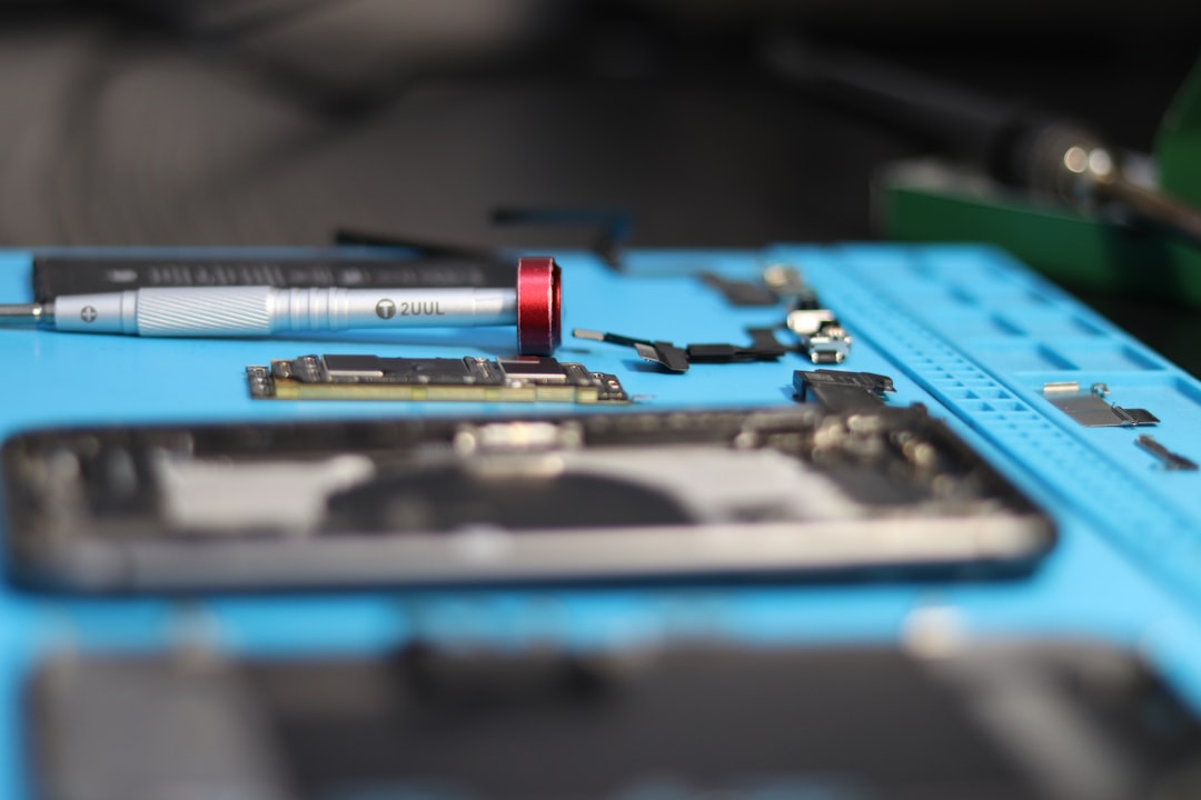 Phone parts are being repaired with tools.