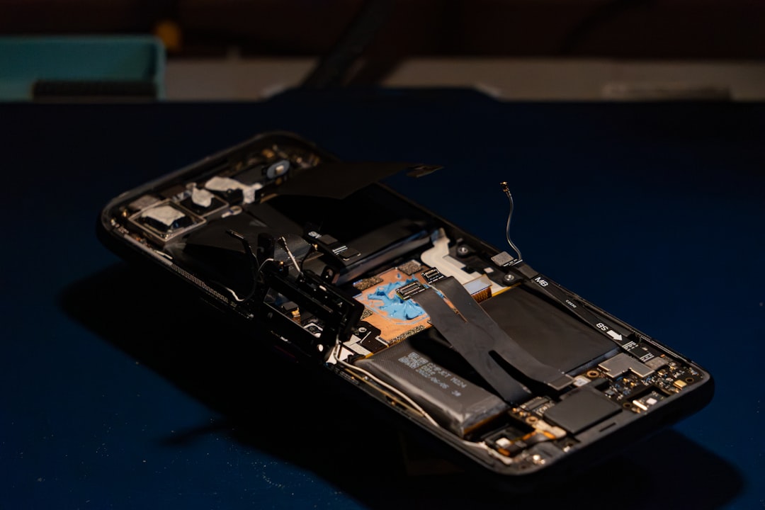Disassembled smartphone revealing internal electronic components.