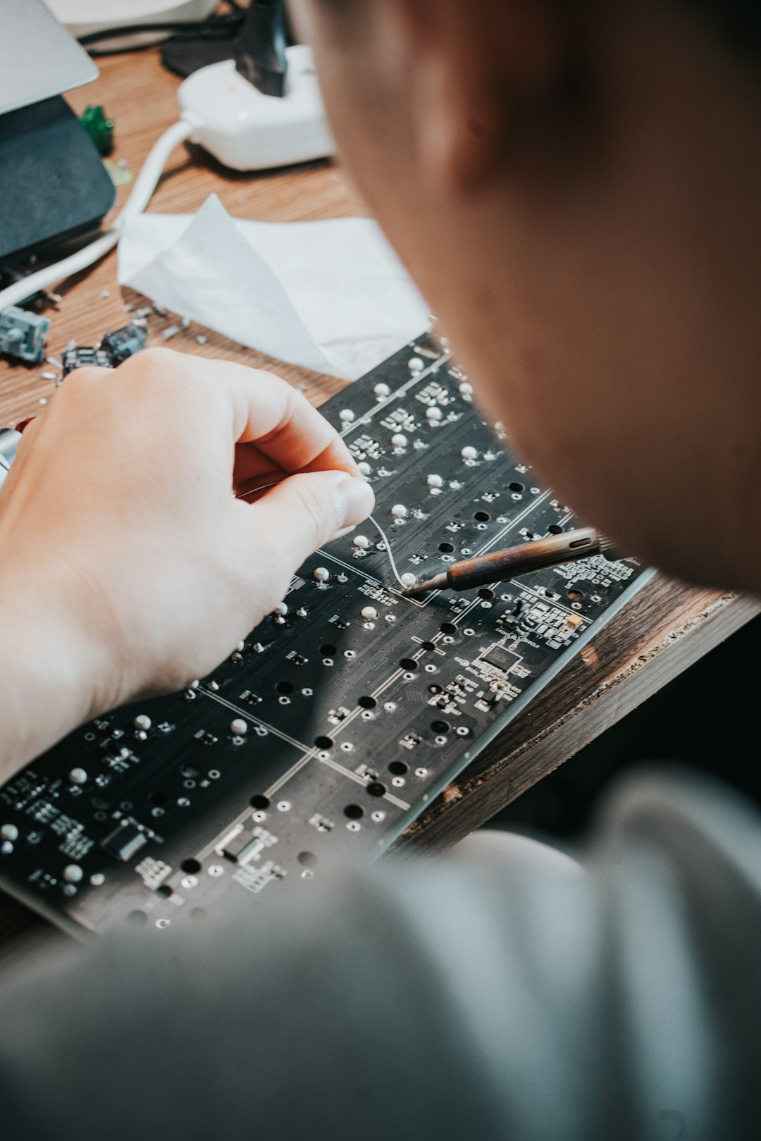 A man is working on a circuit board