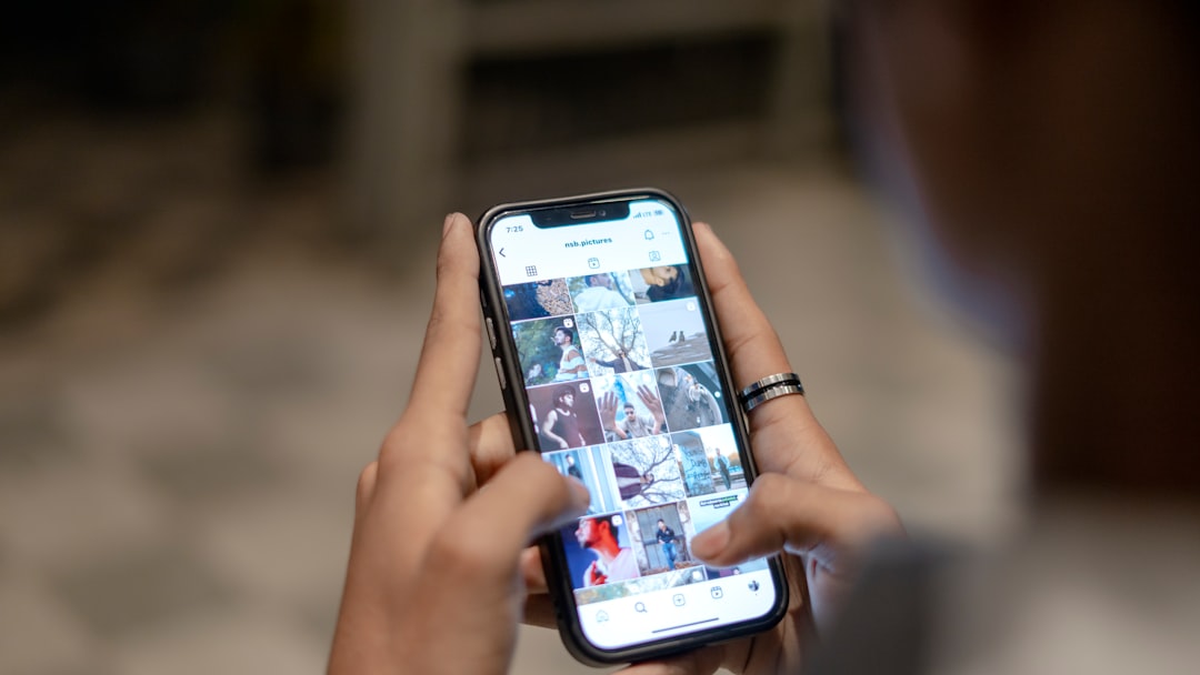 a person holding a cell phone in their hand