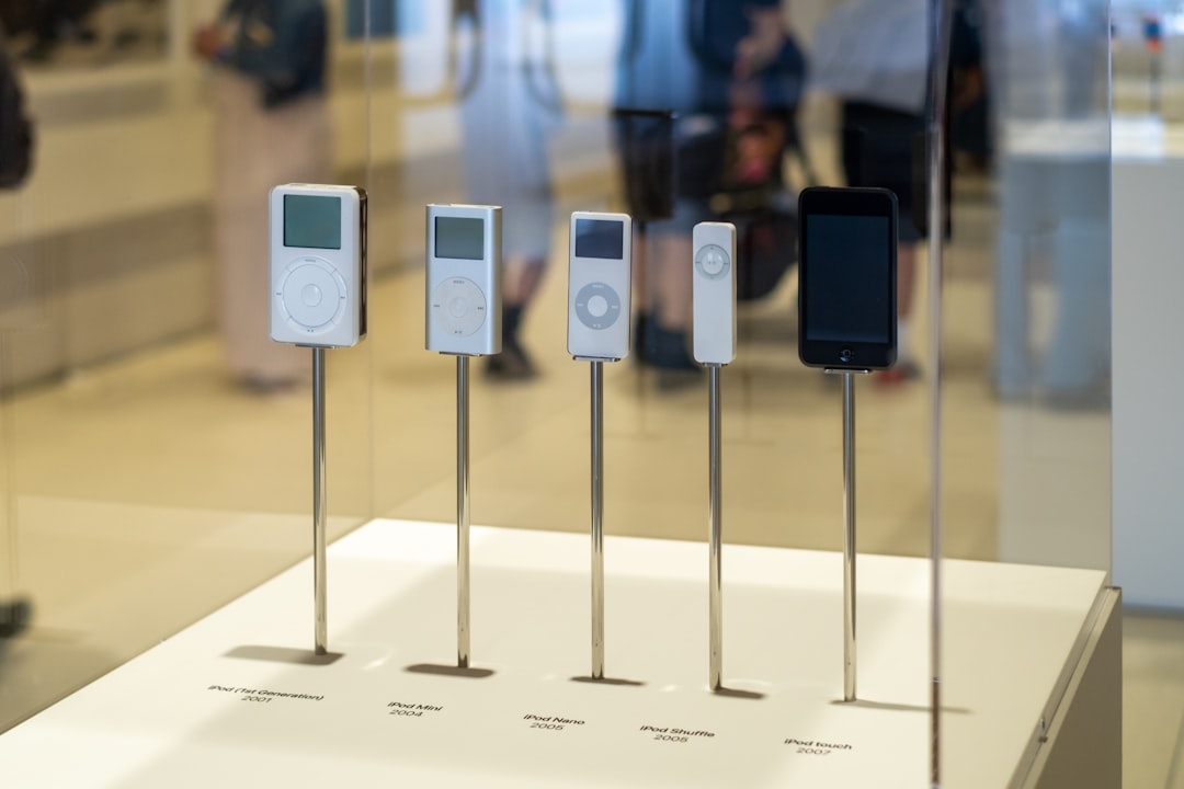 A display of various iPod models and an early iphone.