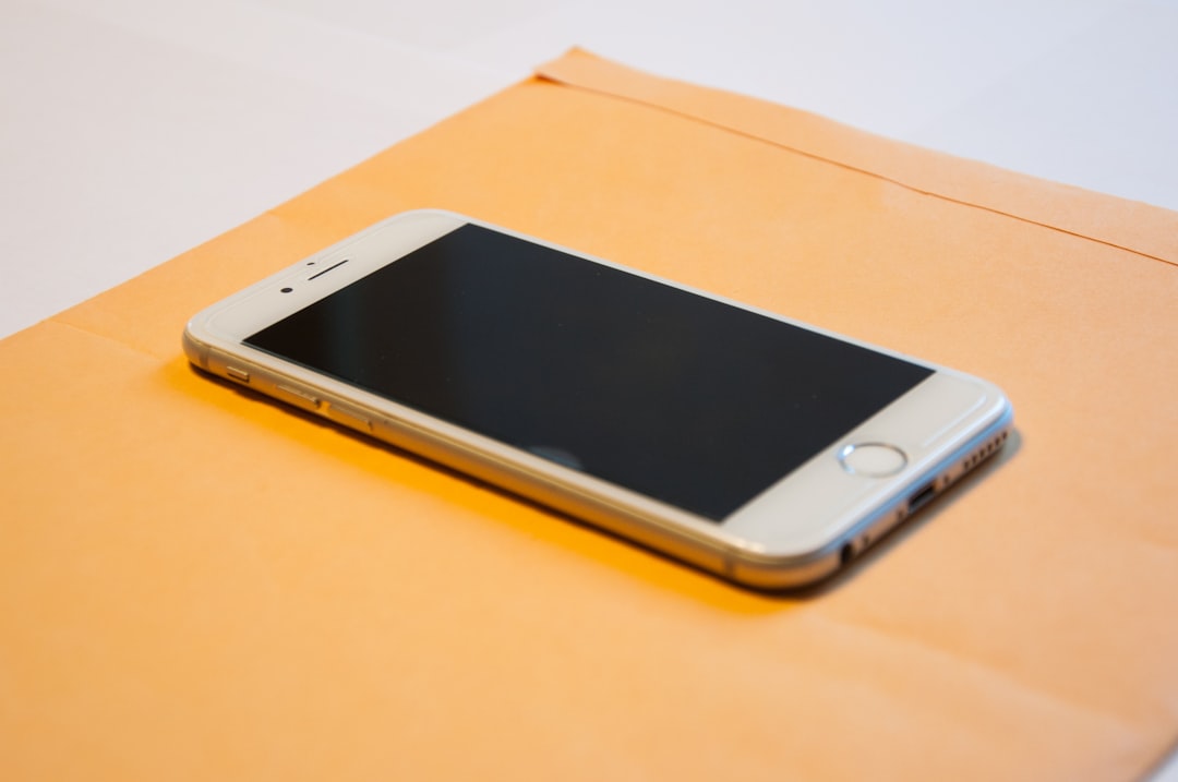 gold iPhone 8 plus on orange envelope
