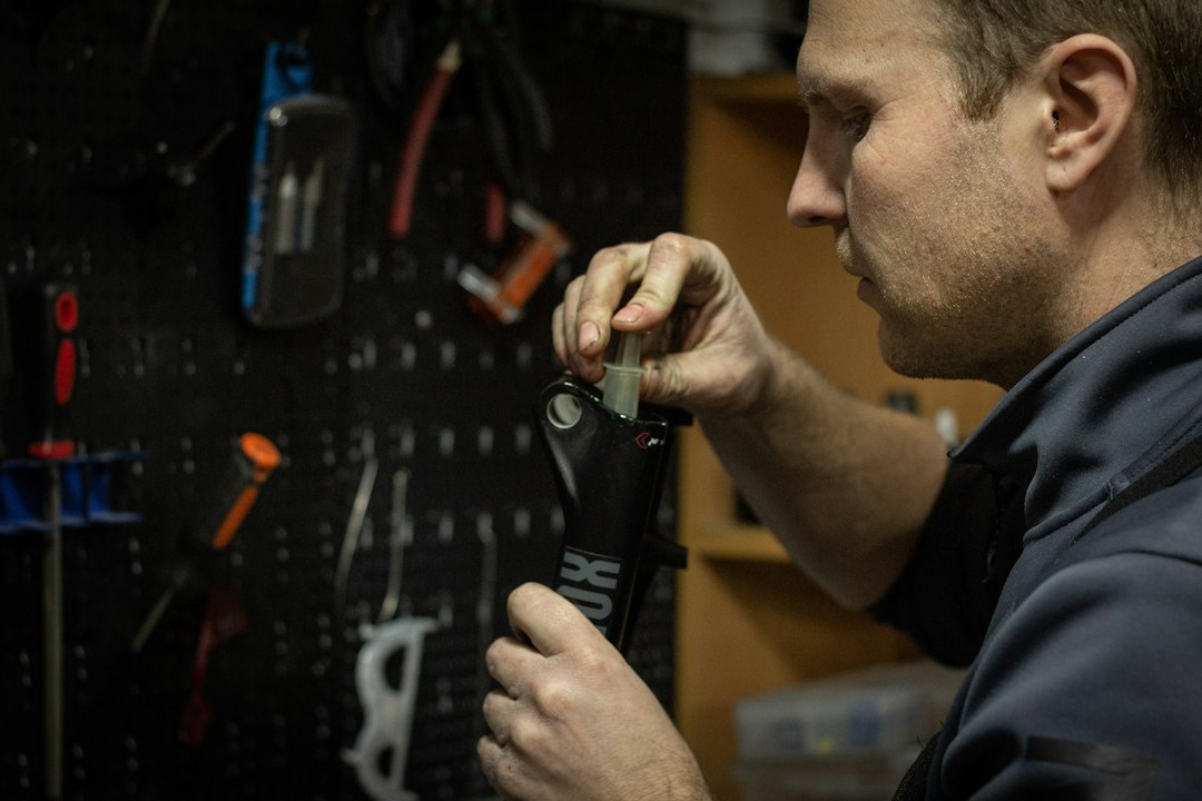 a man working on a tool in a garage