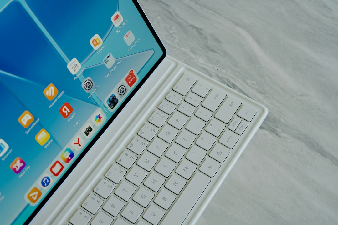 A white tablet with a touchscreen interface and a matching white keyboard cover